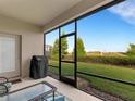 Relaxing screened porch with backyard access and grill at 516 Pamplona Pl, Davenport, FL 33837