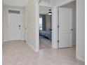 Spacious entryway featuring neutral tile flooring, white walls, and doorways leading to other rooms at 1687 Park Side Ave, Kissimmee, FL 34744