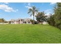 Beautiful single-story home with manicured lawn and mature trees, showcasing its curb appeal at 1960 Jan Lan Blvd, St Cloud, FL 34772