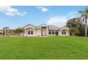 Inviting single-story home featuring a lush front lawn, elegant windows, and a welcoming entrance at 1960 Jan Lan Blvd, St Cloud, FL 34772