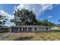 Lovely single-story home featuring gray garage door, brick accents, and a well-maintained front lawn at 6025 Se 119Th Pl, Belleview, FL 34420