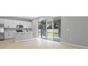 Open kitchen and dining area lead to backyard patio through sliding glass doors at 1488 August Gray Dr, Kissimmee, FL 34744