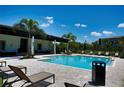 Resort-style community pool with ample seating, palm trees, and a covered lounge area at 6078 Bimini Twist Loop, Orlando, FL 32819