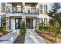 Inviting townhome entrance featuring stone accents, private balconies, and manicured landscaping at 1800 Houston St, Kissimmee, FL 34743