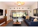 Bright living room with hardwood floors, comfy sofas, and view to the backyard at 504 Ridge View Dr, Davenport, FL 33837
