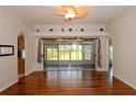 Bright living room featuring hardwood floors, fan and sliding glass doors to the screened lanai at 504 Ridge View Dr, Davenport, FL 33837