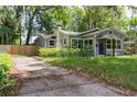 Well-maintained home showcasing a paved driveway, lush lawn, and charming architectural details at 527 Noble Ave, Davenport, FL 33837