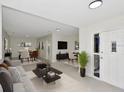 Open-concept living room and dining area with modern decor and plenty of natural light at 1234 Lynwood Ave, Apopka, FL 32703