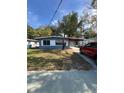 Attractive single-story home with a red-roofed carport and mature landscaping at 1505 S Westmoreland Dr, Orlando, FL 32805