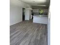 Inviting open-concept living room with modern gray flooring and bright white walls at 1505 S Westmoreland Dr, Orlando, FL 32805