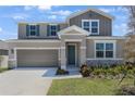 Charming two-story home featuring a two-car garage and professionally landscaped yard at 1698 Sugarbelle Cir, Mascotte, FL 34753