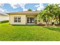 The house has a well-maintained yard with green grass and palm trees at 753 Largo Pass, Poinciana, FL 34759