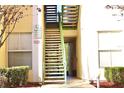 A close up of the building's outdoor staircase used to access the upper floor units at 8830 Dunes Ct # 12 207, Kissimmee, FL 34747