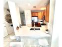Bright kitchen featuring stainless steel appliances, light countertops and breakfast bar at 10786 Savannah Wood Dr # 126, Orlando, FL 32832