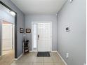 Bright and spacious entryway with tile flooring and access to other rooms at 1940 Banner Ln, St Cloud, FL 34769