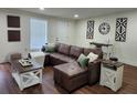 Living room with brown leather sofa, stylish decor, and ample lighting at 4950 Nova Ave, St Cloud, FL 34773