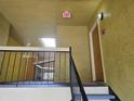 Hallway showing stairway, doorways and an overhead exit sign and skylight at 5267 Images Cir # 303, Kissimmee, FL 34746
