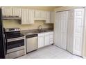 Kitchen with white cabinets, granite countertops, and stainless steel appliances at 1069 Universal Rest Pl, Kissimmee, FL 34744