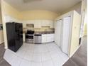 A bright, compact kitchen featuring stainless steel appliances and white cabinetry at 1069 Universal Rest Pl, Kissimmee, FL 34744