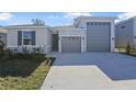 Modern house with attached garage, driveway, and landscaping at 1744 Carnelian St, Deland, FL 32720
