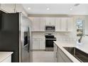 Modern kitchen with stainless steel appliances and white cabinets at 1744 Carnelian St, Deland, FL 32720