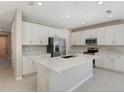 Modern kitchen with white cabinets, stainless steel appliances, and an island at 1744 Carnelian St, Deland, FL 32720