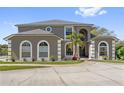 Beautiful two-story home with an inviting entrance and circular driveway at 1810 Markham Woods Rd, Longwood, FL 32779