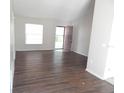 Bright living room featuring laminate flooring and large window providing lots of natural light at 4815 Jay Dr, St Cloud, FL 34772