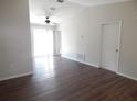 Bright living room with ceiling fan, laminate flooring and sliding glass doors leading to patio at 4815 Jay Dr, St Cloud, FL 34772