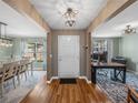Bright and spacious entryway with hardwood floors, leading to dining and office areas at 545 Pintail Cir, Auburndale, FL 33823