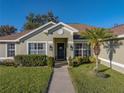 Well-maintained house with a landscaped lawn and walkway at 545 Pintail Cir, Auburndale, FL 33823
