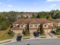 Aerial view of townhome community, showcasing multiple tan townhomes at 8121 Roseville Blvd, Davenport, FL 33896