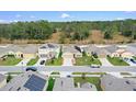 Aerial view of a street with houses and solar panels at 965 Shady Tree Ln, Davenport, FL 33897