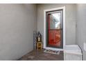 Front entry with red door, welcome mat, and lantern decor at 113 Promenade Ct, Auburndale, FL 33823