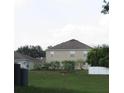 Rear view of two story house with fenced backyard at 137 Milestone Dr, Haines City, FL 33844