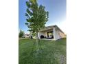 Covered patio, grassy yard, and outdoor seating area at 14827 Milfoil Ave, Orlando, FL 32827