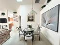 Dining room features a round glass table and wall art at 2511 La Jolla Trl, Kissimmee, FL 34747