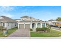 Lovely one-story home with a two-car garage, brick driveway, and lush green lawn, nestled in a suburban neighborhood at 19041 Blueleaf St, Orlando, FL 32827