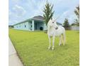 Charming single-story home with lush lawn and whimsical unicorn statue at 19041 Blueleaf St, Orlando, FL 32827