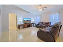 Bright living room featuring leather seating and a large TV at 25 Juniper Loop Cir, Ocala, FL 34480
