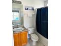 Clean bathroom with tub shower, toilet and wood vanity at 2981 Kokomo Loop, Haines City, FL 33844