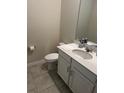 Small bathroom with white vanity, toilet, and tiled floor at 2986 Aqua Virgo Loop, Orlando, FL 32837