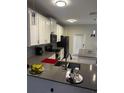 Modern kitchen with white cabinets, gray countertops, and island at 2986 Aqua Virgo Loop, Orlando, FL 32837
