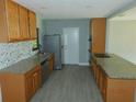 Well-lit kitchen boasts granite countertops and stainless steel appliances at 436 Michigan Ave, St Cloud, FL 34769