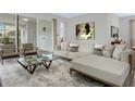 Spacious living room with L-shaped sofa and large windows at 9022 Pelican Cove Trce, Kissimmee, FL 34747