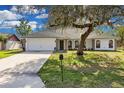 Newly renovated single-story home with a large tree and mailbox at 1812 Corolla Ct, Deltona, FL 32738