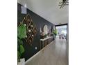 Stylish hallway with modern decor, accent lighting, and view of the dining room at 2459 Taloncrest Ct, Eagle Lake, FL 33839