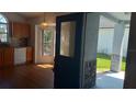 Entryway with view of the kitchen, featuring a decorative glass door and tiled backsplash at 2645 Oneida Loop, Kissimmee, FL 34747