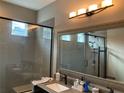 Elegant bathroom with a large mirror and glass shower at 3306 Sagebrush St, Harmony, FL 34773