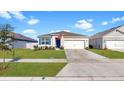 One-story house featuring a two-car garage and manicured lawn at 5109 Barombi Bnd, Saint Cloud, FL 34772